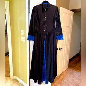 Black and blue long sleeved dress with button detail and front zipper closure.